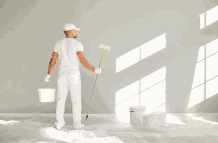 Professional painter decorating a bright commercial interior