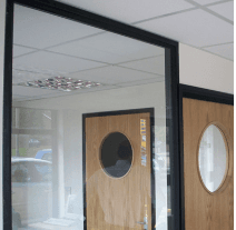 Black framed glass office partitioning with timber doors